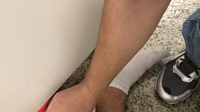 Punhetando um safado por debaixo da divisoria no shopping 