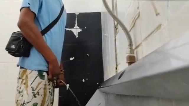 Brazilian men pissing at bathroom
