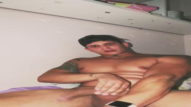 Mathius Butler sitting on the bed with a hard penis.